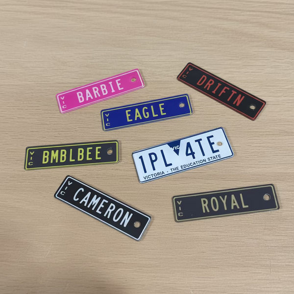 Various small rectangular keyrings on a wooden surface