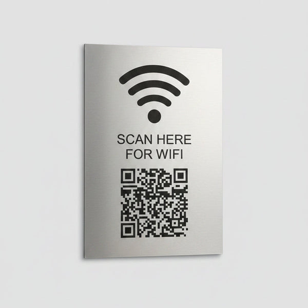 Metal sign with QR code and text 'Scan here for wifi' on a white background