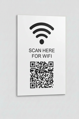 White sign with WiFi symbol and QR code on a gray background