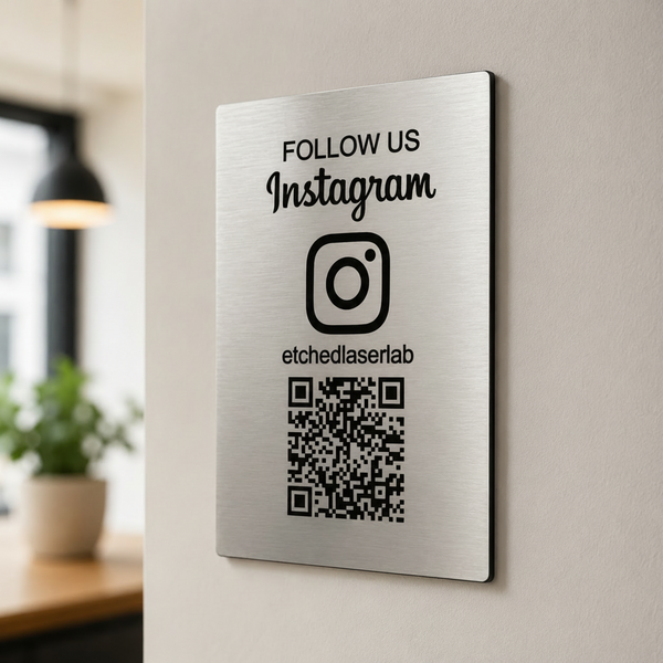 Metal sign with Instagram follow message and QR code on a wall.